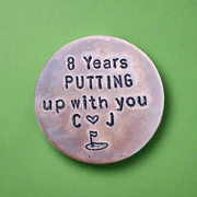 8 Years golf ball marker.