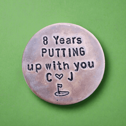 8 Years golf ball marker.