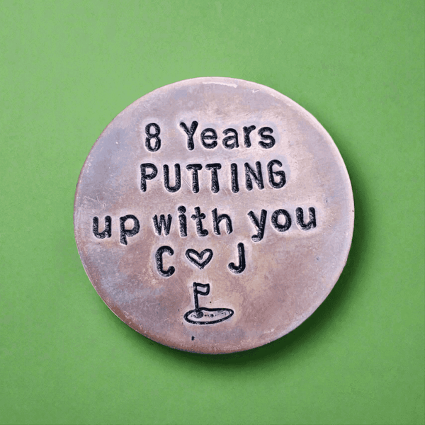 8 Years golf ball marker.