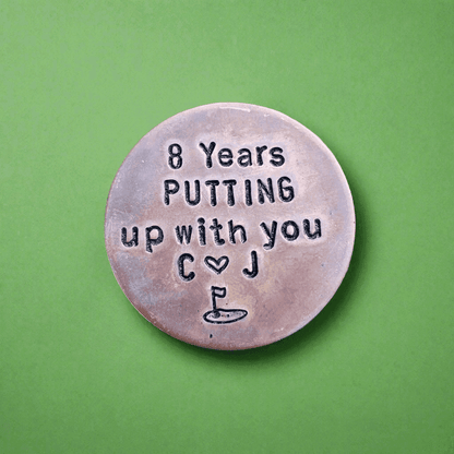 8 Years golf ball marker.