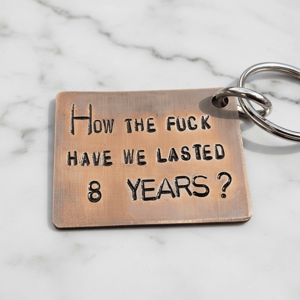 8th Anniversary bronze keychain with the phrase 'How the fuck have we lasted 8 years?' hand stamped design