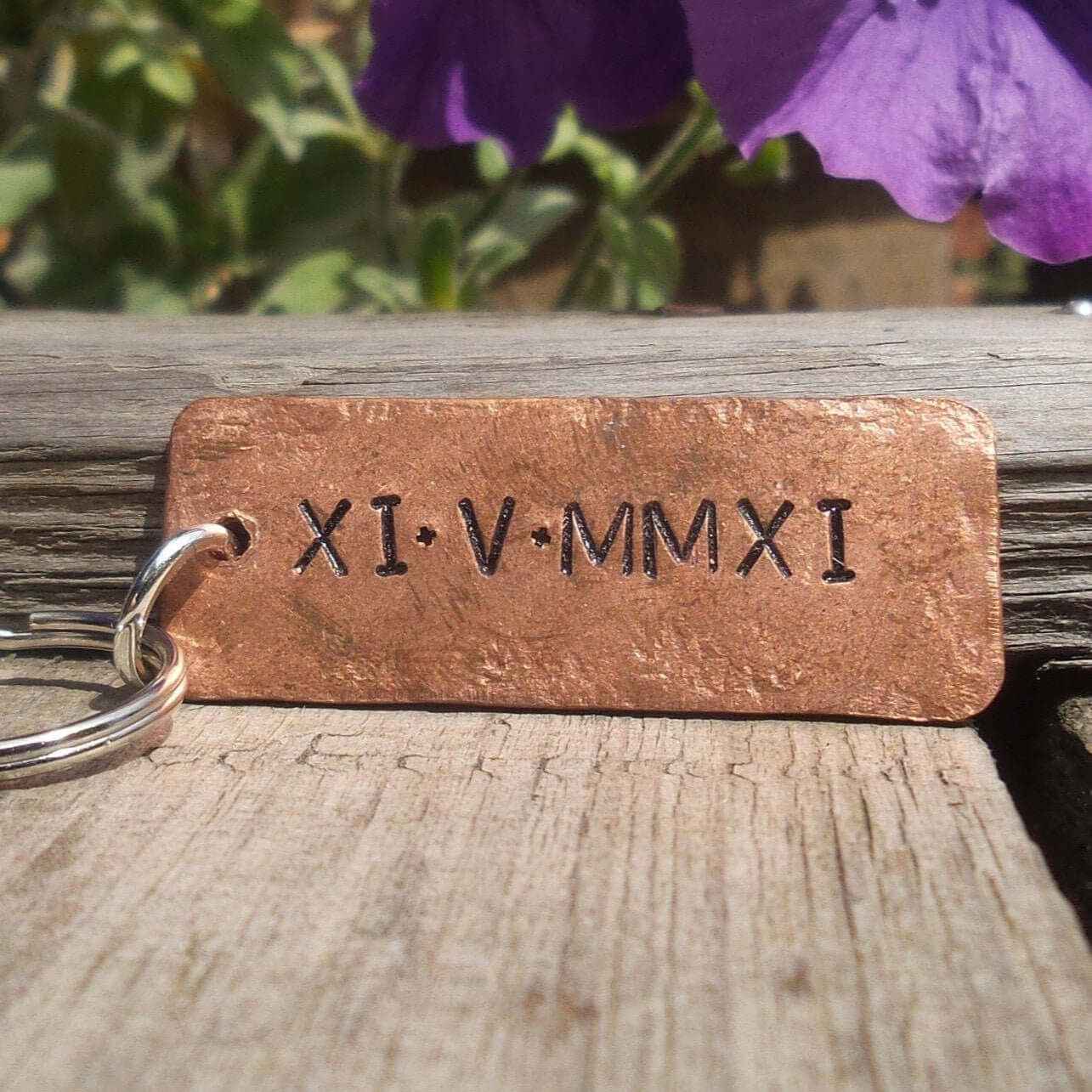 Roman Numerals Keychain made of solid copper, personalized with unique Roman numeral date XI·V·MMXI.