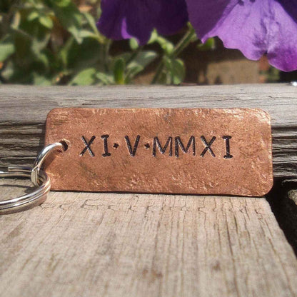 Roman Numerals Keychain made of solid copper, personalized with unique Roman numeral date XI·V·MMXI.